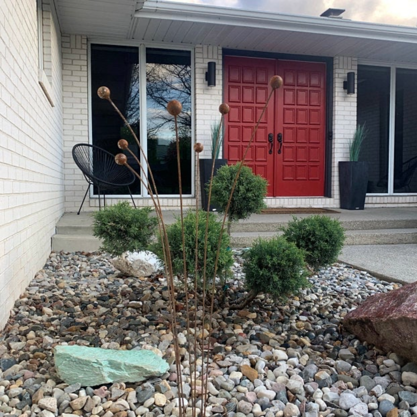 Metal garden art in front of modern house